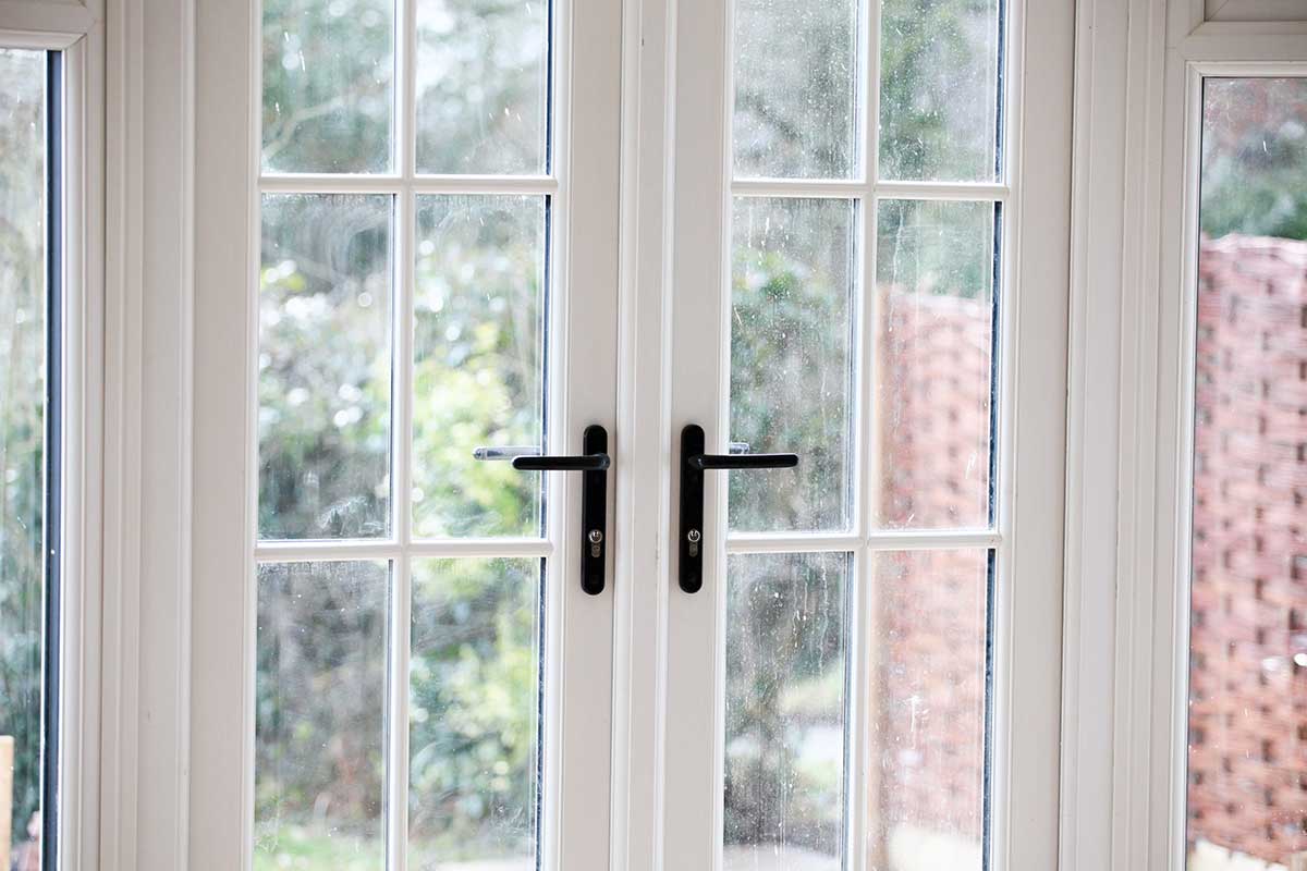 Liniar french doors installed at a home looking out to a garden 