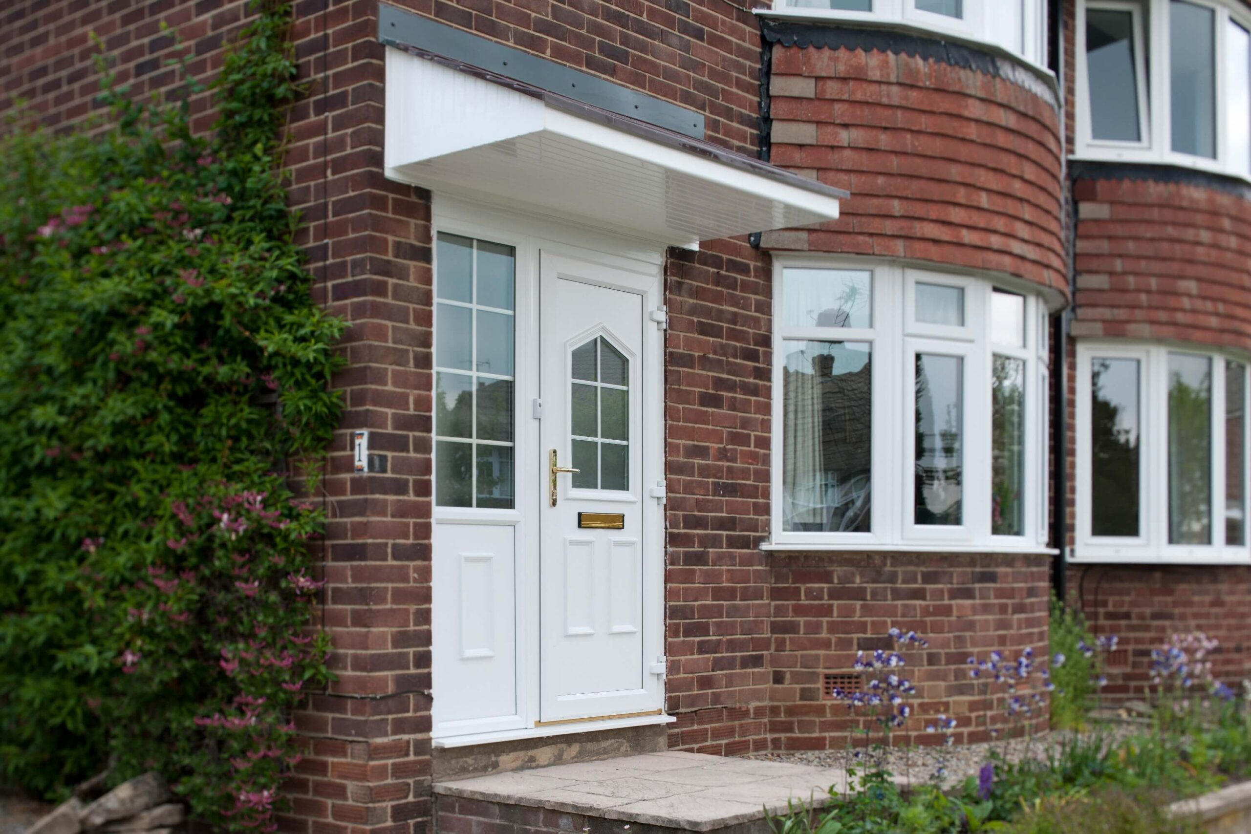 residential home with red brick and white door
